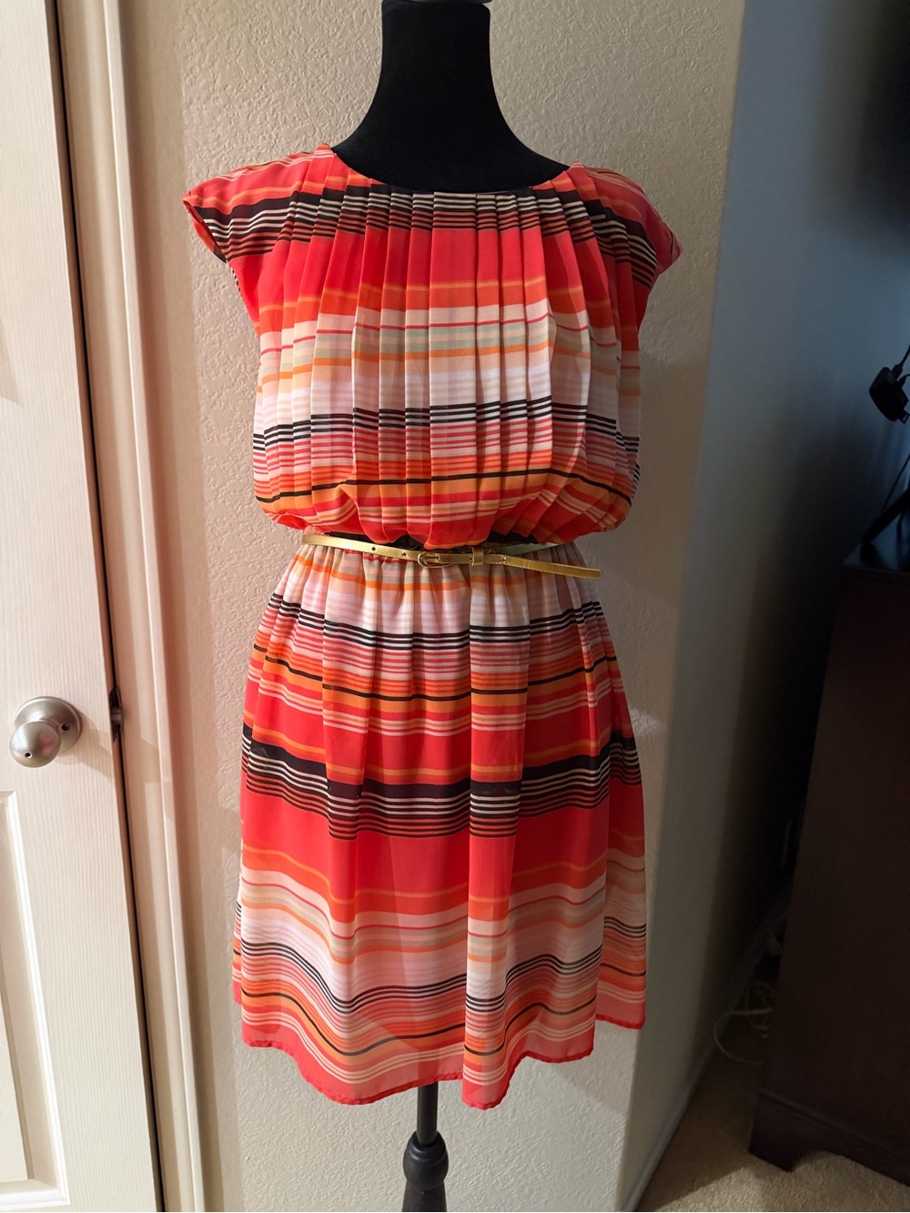 This colorful pleated dress can brighten up your wardrobe.